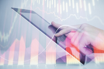 Multi exposure of man's hands holding and using a digital phone and forex graph drawing. Financial market concept.