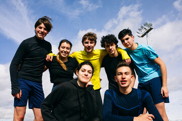 Happy teen athletes taking selfie on track