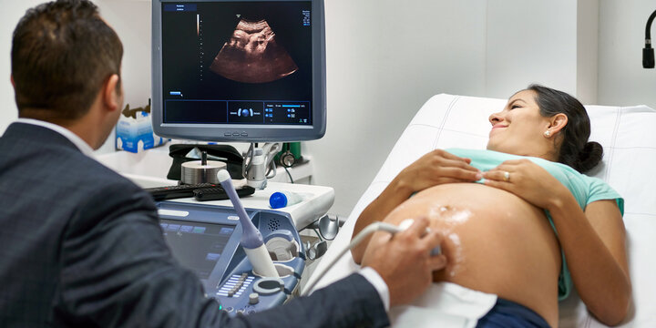 Pregnant woman seeing her unborn baby on an ultrasound screen