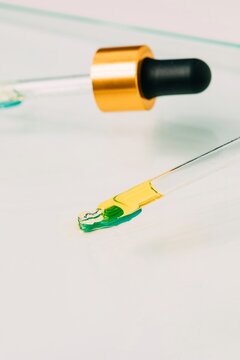 Droppers with cosmetic products on glass table