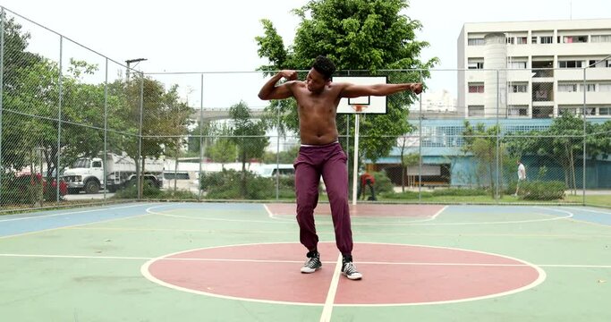 African man krumping at basketball court