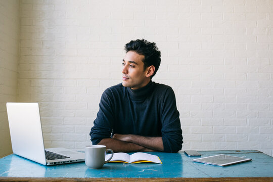 Pensive businessman sitting at desk