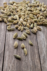 Narrow focus cardamom seeds over wooden table