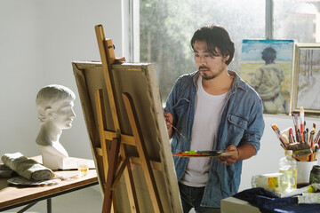 Male artist woking in studio