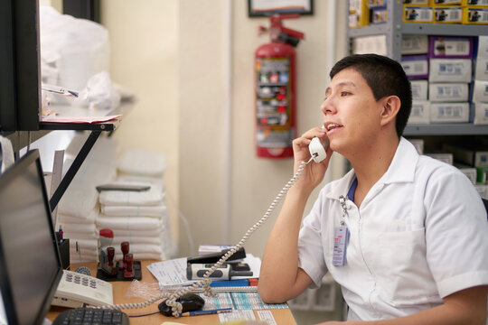 Medical professional in a supply taking an order on the phone