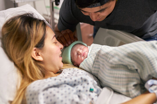 Happy mother and father with their newborn in a hospital