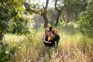 Mother and daughter using binoculars