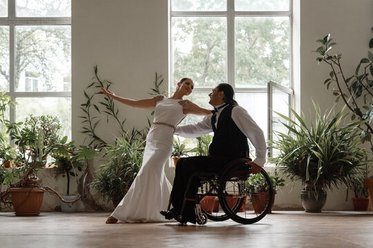 Couple practicing wheelchair dance in studio