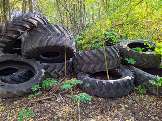 polygon of old and huge tires outdoors in the autumn season