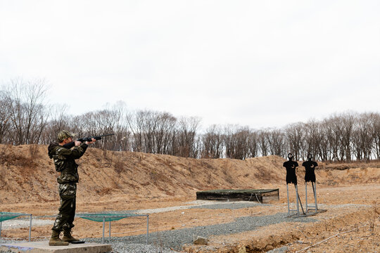 Man in camouflage shooting at targets