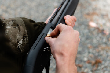 Crop hunter preparing rifle for shooting
