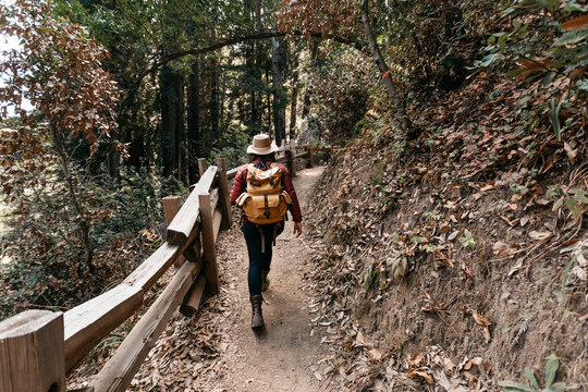 An African American woman explorer, hiking and taking photos in nature.