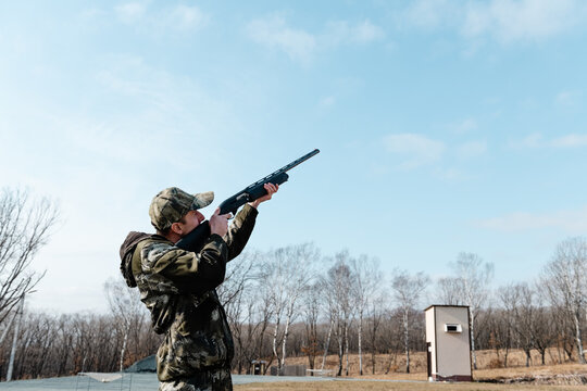 Hunter aiming weapon on shooting range