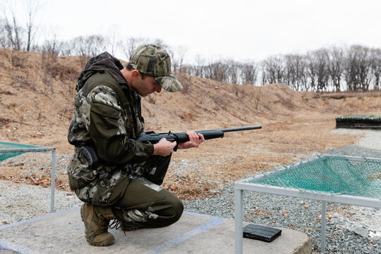 Man preparing gun for shooting