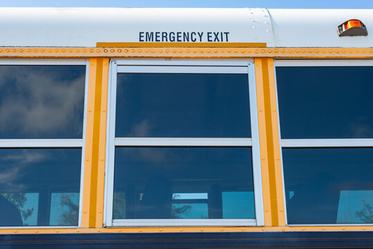 Emergency exit on the side of a yellow school bus