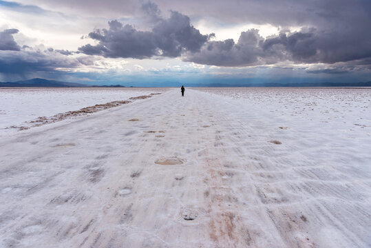 Woman walking on Salinas Grandes Salt flats