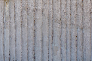 Old, rough and bumpy raw concrete wall with remain of wooden formwork stamped. 