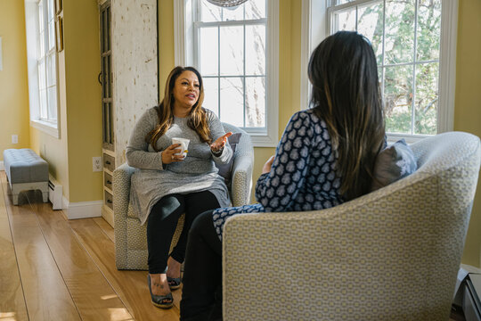 Doula Meeting with Expectant Hispanic Woman at luxury home
