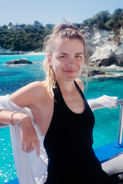 Portrait of a young female model on the boat at sea