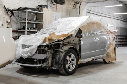 Broken vehicle with cover in garage