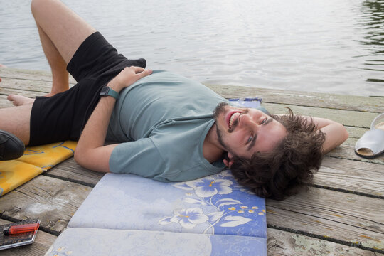 Young man laying down and relaxing on the river raft
