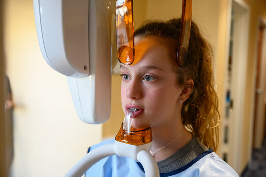Young Patient getting mouth x-ray in radiology department of Orthodontist office