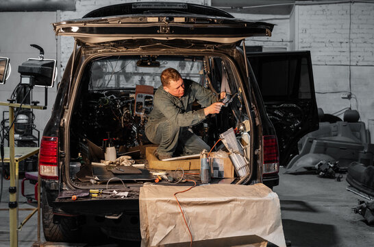 Repairman checking insides of car