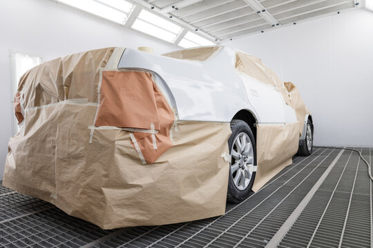 White car covered with paper in garage