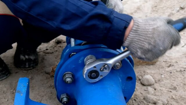 Workers installing water supply pipeline system, close up