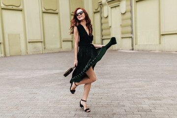 Pretty lady in velvet dress posing outside