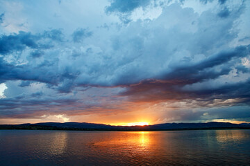 Dramatic clouds over the lake. Sunset. Storm.