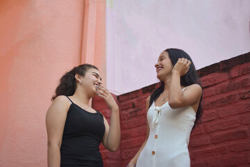 Two happy girlfriends smiling