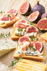 bruschetta with blue cheese, prosciutto and fresh figs, selective focus.