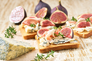 bruschetta with blue cheese, prosciutto and fresh figs, selective focus.