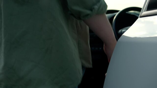 Beautiful woman getting in car outdoors