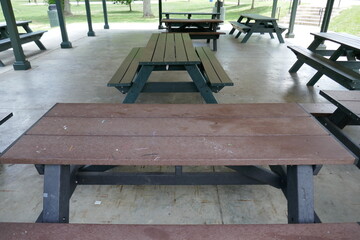 Picnic tables lined up in public park shelter house
