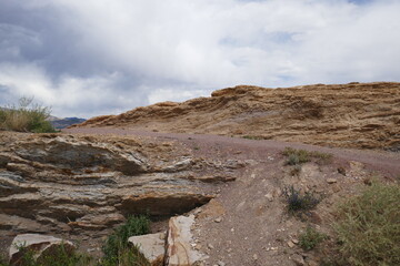 Fototapeta na wymiar Dirt hiking path going over jagged rock formation