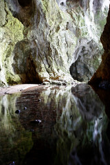 Reflection of rocks in the water in the cave