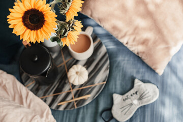 Cozy Autumn mood. Fall season. Bedroom vibes. Sunflowers, coffee, pumpkin. Morning light. Eye night mask. Comfortable bed. Lazy chill morning. Enjoying the little things. Blue and yellow. September.