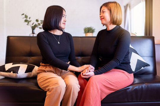 Couple lesbian giving hands together at home,Suicide prevention,Positive attitude and open mind,Mental health care concept
