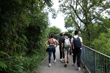 young men, women or boys and girls, university students with face masks hiking along trails in Victoria Peak, Hong Kong during covid-19