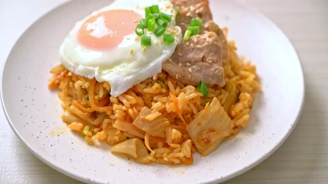 Kimchi fried rice with fried egg and pork - Korean food style
