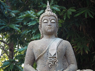 A white buddha statue in the forest