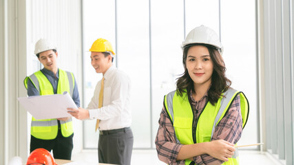 Portrait of confident female construction worker at construction site in office.