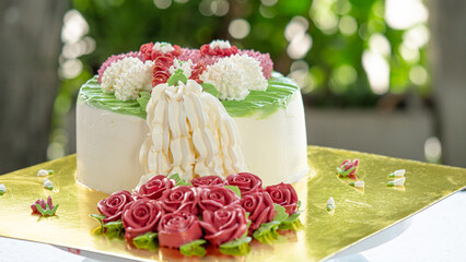 The cake is decorated with a garland of roses made from creamer. Beautiful to eat and delivered as...
