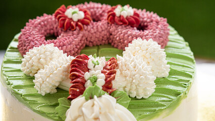The cake is decorated with a garland of roses made from creamer. Beautiful to eat and delivered as...