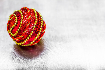 Obraz na płótnie Canvas Red Christmas ball on background. Christmas background. Winter holiday Christmas theme. Happy New Year. Place for your text. Selective focus