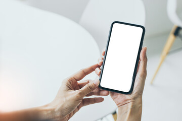 cell phone mockup blank white screen.woman hand holding texting using mobile on desk at coffee shop.background empty space for advertise.work people contact marketing business,technology