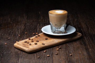 Coffee cup and beans on old kitchen table. Cappuccino mocha flat white Irish coffee macchiato or...