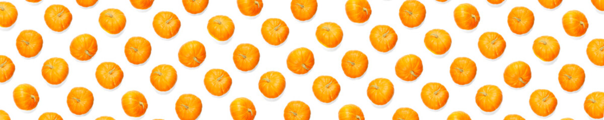 Autumn background made frem pumpkin. Background of orange miniature pumpkins. Thanksgiving or halloween background